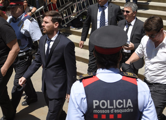 Barcelona's football star Lionel Messi (L) leaves the courthouse on June 2, 2016 in Barcelona. The 28-year-old football star was cheered and jeered as he emerged from a van accompanied by his father Jorge Horacio Messi. The two are accused of using a chain of fake companies in Belize and Uruguay to avoid paying taxes on 4.16 million euros ($4.6 million) of Messi's income earned through the sale of his image rights from 2007-09. 