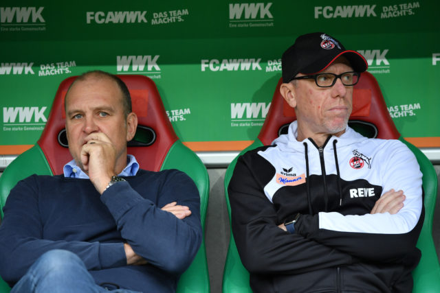 AUGSBURG, GERMANY - SEPTEMBER 09: Joerg Schmadtke, sports director of Koeln (L) and head coach Peter Stoeger of Koeln look in opposite directions during the Bundesliga match between FC Augsburg and 1. FC Koeln at WWK-Arena on September 9, 2017 in Augsburg, Germany. (Photo by Sebastian Widmann/Bongarts/Getty Images)