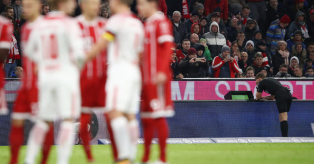 MUNICH, GERMANY - OCTOBER 28: Referee Daniel Siebert looks at the video footage after a foul by Willi Orban of Leipzig (not seen), which results in a red card, during the Bundesliga match between FC Bayern Muenchen and RB Leipzig at Allianz Arena on October 28, 2017 in Munich, Germany. (Photo by Alex Grimm/Bongarts/Getty Images)