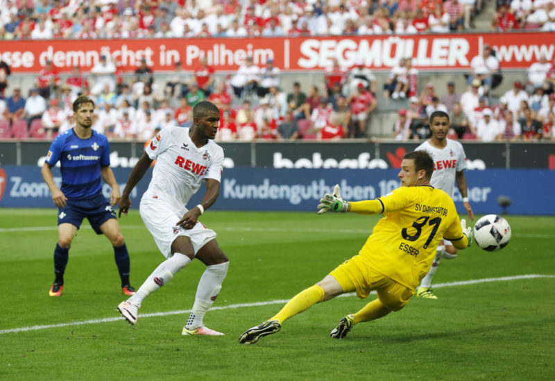 Cologne's French forward Anthony Modeste (2nd L) scores the 2-0 against Darmstadt's goalkeeper Michael Esser (R) during the German first division Bundesliga football match of FC Cologne vs SV Darmstadt 98 in Cologne, western Germany, on August 27, 2016. / AFP / NORBERT SCHMIDT / RESTRICTIONS: DURING MATCH TIME: DFL RULES TO LIMIT THE ONLINE USAGE TO 15 PICTURES PER MATCH AND FORBID IMAGE SEQUENCES TO SIMULATE VIDEO. == RESTRICTED TO EDITORIAL USE == FOR FURTHER QUERIES PLEASE CONTACT DFL DIRECTLY AT + 49 69 650050 (Photo credit should read NORBERT SCHMIDT/AFP/Getty Images)