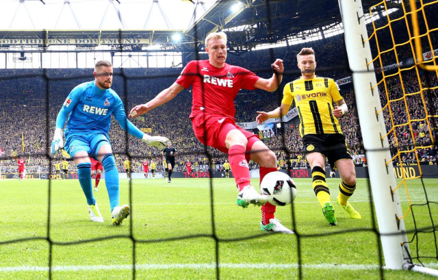 DORTMUND, GERMANY - APRIL 29: Frederik Soerensen of Koeln stops a shot of Marco Reus of Dortmund during the Bundesliga match between Borussia Dortmund and 1. FC Koeln at Signal Iduna Park on April 29, 2017 in Dortmund, Germany. (Photo by Lars Baron/Bongarts/Getty Images)