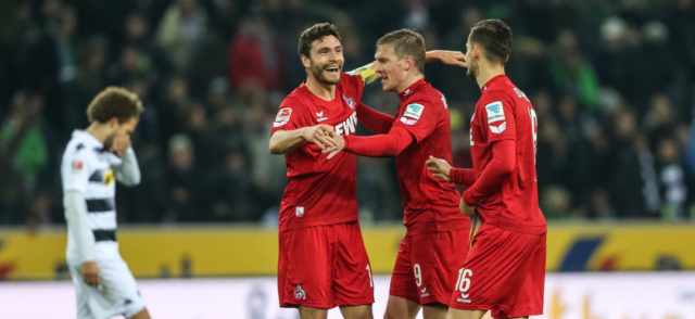 MOENCHENGLADBACH, GERMANY - NOVEMBER 19: (L-R) Jonas Hector, Artjoms Rudnevs and Pawel Olkowski of Koeln celebrate after winning the Bundesliga match between Borussia Moenchengladbach and 1. FC Koeln at Borussia-Park on November 19, 2016 in Moenchengladbach, Germany.