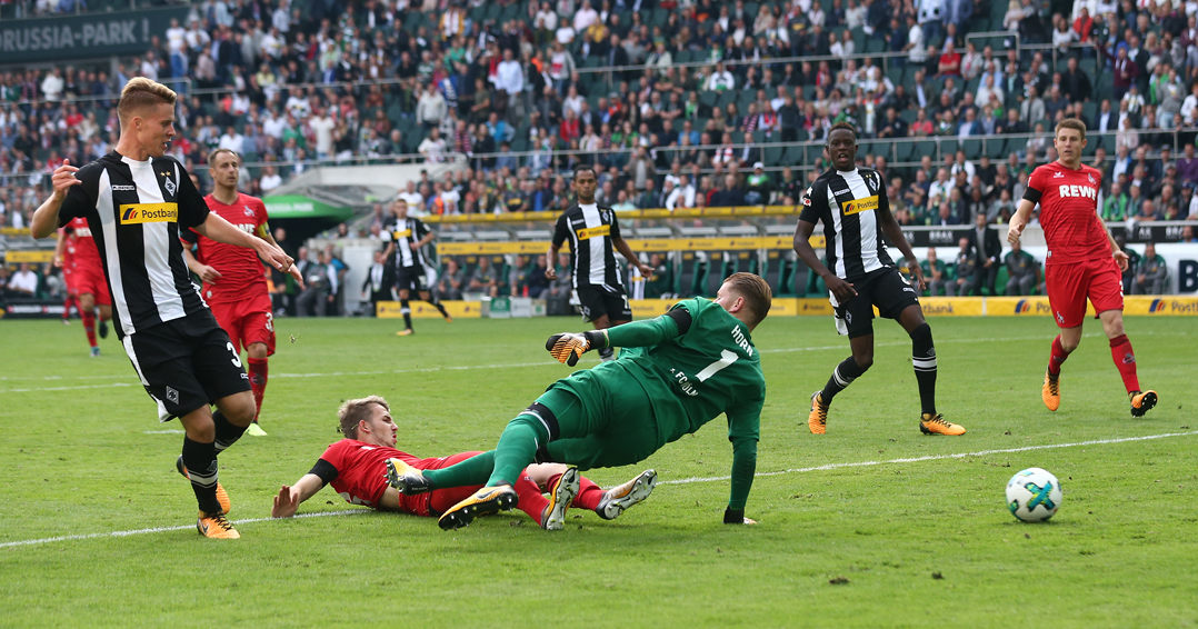 MOENCHENGLADBACH, GERMANY - AUGUST 20: Nico Elvedi of Moenchengladbach (left) scores his teams first goal past goalkeeper Timo Horn of Koeln during the Bundesliga match between Borussia Moenchengladbach and 1. FC Koeln at Borussia-Park on August 20, 2017 in Moenchengladbach, Germany. (Photo by Christof Koepsel/Bongarts/Getty Images)