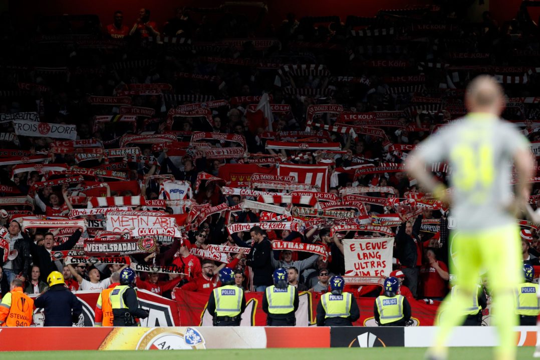 Cologne's supporters raise their scarves in the crowd during the UEFA Europa League Group H football match between Arsenal and FC Cologne at The Emirates Stadium in London on September 14, 2017. / AFP PHOTO / Adrian DENNIS (Photo credit should read ADRIAN DENNIS/AFP/Getty Images)