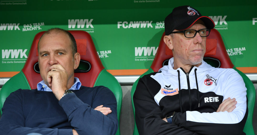 AUGSBURG, GERMANY - SEPTEMBER 09: Joerg Schmadtke, sports director of Koeln (L) and head coach Peter Stoeger of Koeln look in opposite directions during the Bundesliga match between FC Augsburg and 1. FC Koeln at WWK-Arena on September 9, 2017 in Augsburg, Germany. (Photo by Sebastian Widmann/Bongarts/Getty Images)