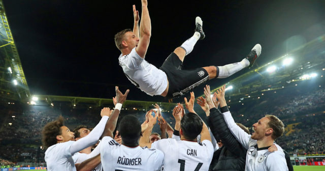 DORTMUND, GERMANY - MARCH 22: Lukas Podolski is thrown in the air by his team mates after playing his last game for Germany during the international friendly match between Germany and England at Signal Iduna Park on March 22, 2017 in Dortmund, Germany. (Photo by Alex Grimm/Bongarts/Getty Images)