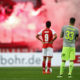 MAINZ, GERMANY - NOVEMBER 18: Yoshinori Muto #9 of Mainz and Matthias Lehmann of Koeln react as fans of Koeln burn flares during the Bundesliga match between 1. FSV Mainz 05 and 1. FC Koeln at Opel Arena on November 18, 2017 in Mainz, Germany. (Photo by Alex Grimm/Bongarts/Getty Images)