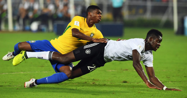 Yann Bisseck of Germany and Lincoln (L) of Brazil compete for the ball during the quarterfinal football match of the FIFA U-17 World Cup at the Vivekananda Yuba Bharati Krirangan stadium in Kolkata on October 22, 2017. The FIFA U-17 Football World Cup is taking place in India from October 6 to 28. / AFP PHOTO / Dibyangshu SARKAR (Photo credit should read DIBYANGSHU SARKAR/AFP/Getty Images)