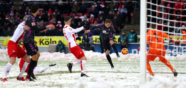 COLOGNE, GERMANY - DECEMBER 10: Nils Petersen of SC Freiburg shoots and scores his side's first goal during the Bundesliga match between 1. FC Koeln and Sport-Club Freiburg at RheinEnergieStadion on December 10, 2017 in Cologne, Germany. (Photo by Dean Mouhtaropoulos/Bongarts/Getty Images)