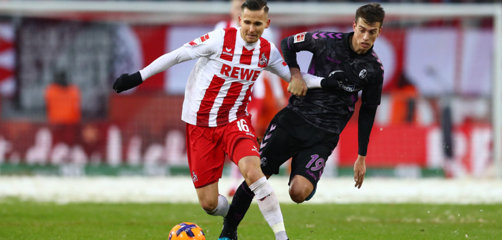 COLOGNE, GERMANY - DECEMBER 10: Pawel Olkowski of FC Koeln and Janik Haberer of SC Freiburg battle for the ball during the Bundesliga match between 1. FC Koeln and Sport-Club Freiburg at RheinEnergieStadion on December 10, 2017 in Cologne, Germany. (Photo by Dean Mouhtaropoulos/Bongarts/Getty Images)