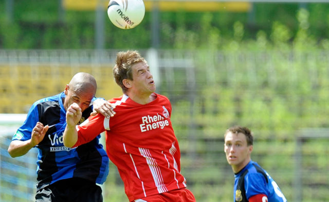 Marc Lerandy of Saarbruecken battles for the ball with Simon Terodde of Koeln during the Regionalliga match between 1.FC Saarbruecken and 1.FC Koeln II at Ludwigspark stadium on May 22, 2010 in Saarbruecken, Germany.