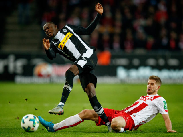 COLOGNE, GERMANY - JANUARY 14: Denis Zakaria of Moenchegladbach is challenged by Simon Terodde of Koeln during the Bundesliga match between 1. FC Koeln and Borussia Moenchengladbach at RheinEnergieStadion on January 14, 2018 in Cologne, Germany. 