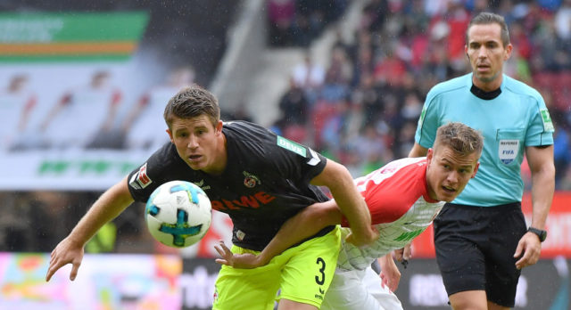 AUGSBURG, GERMANY - SEPTEMBER 09: Dominique Heintz of Koeln and Alfred Finnbogason of Augsburg compete for the ball during the Bundesliga match between FC Augsburg and 1. FC Koeln at WWK-Arena on September 9, 2017 in Augsburg, Germany. (Photo by Sebastian Widmann/Bongarts/Getty Images)