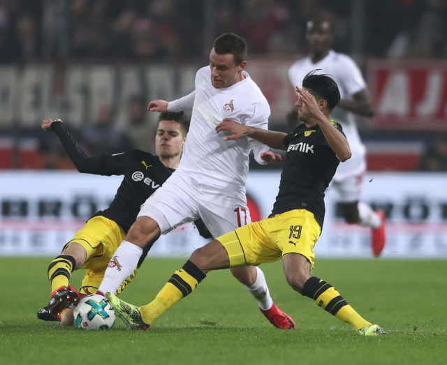 COLOGNE, GERMANY - FEBRUARY 02: Christian Clemens of Cologne is challenged by Julian Weigl and Mahmoud Dahoud of Dortmund during the Bundesliga match between 1. FC Koeln and Borussia Dortmund at RheinEnergieStadion on February 2, 2018 in Cologne, Germany. (Photo by Alex Grimm/Bongarts/Getty Images)