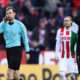 COLOGNE, GERMANY - FEBRUARY 17: Referee Markus Schmidt listens to the video assistant referee VAR on his headphone during the Bundesliga match between 1. FC Koeln and Hannover 96 at RheinEnergieStadion on February 17, 2018 in Cologne, Germany. (Photo by Alex Grimm/Bongarts/Getty Images)