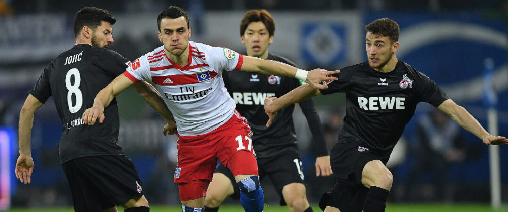 HAMBURG, GERMANY - JANUARY 20: Milos Jojic of Koeln (l) fights for then ball with Filip Kostic of Hamburg during the Bundesliga match between Hamburger SV and 1. FC Koeln at Volksparkstadion on January 20, 2018 in Hamburg, Germany. (Photo by Stuart Franklin/Bongarts/Getty Images)