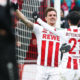 COLOGNE, GERMANY - MARCH 18: Simon Zoller #11 of 1.FC Koeln celebrates with Leonardo Bittencourt #21 of 1.FC Koeln and Marcel Risse #7 of 1.FC Koeln after scoring his teams second goal during the Bundesliga match between 1. FC Koeln and Bayer 04 Leverkusen at RheinEnergieStadion on March 18, 2018 in Cologne, Germany. (Photo by Maja Hitij/Bongarts/Getty Images)