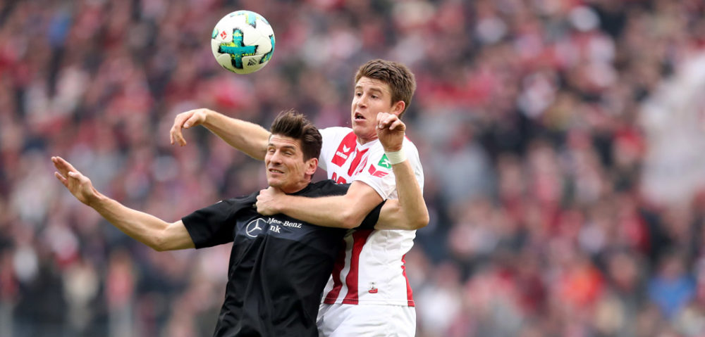 COLOGNE, GERMANY - MARCH 04: (L-R) Mario Gomez of Stuttgart and Frederik Soerensen of Koeln go up for a header during the Bundesliga match between 1. FC Koeln and VfB Stuttgart at RheinEnergieStadion on March 4, 2018 in Cologne, Germany. (Photo by Christof Koepsel/Bongarts/Getty Images)