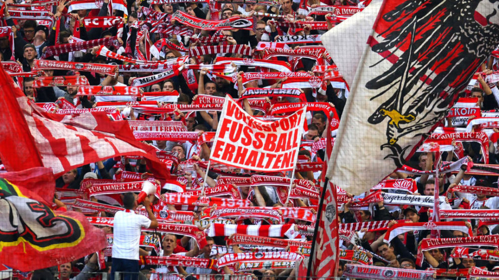 Cologne´s supporters celebrate during the German first division Bundesliga football match between FC Cologne and FC Ingolstadt 04, in Cologne, western Germany, on October 15, 2016. / AFP / PATRIK STOLLARZ / RESTRICTIONS: DURING MATCH TIME: DFL RULES TO LIMIT THE ONLINE USAGE TO 15 PICTURES PER MATCH AND FORBID IMAGE SEQUENCES TO SIMULATE VIDEO. == RESTRICTED TO EDITORIAL USE == FOR FURTHER QUERIES PLEASE CONTACT DFL DIRECTLY AT + 49 69 650050 (Photo credit should read PATRIK STOLLARZ/AFP/Getty Images)