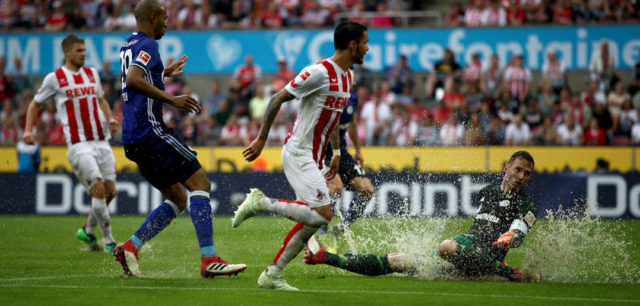 COLOGNE, GERMANY - APRIL 22: Ralf faehrmann (R), goalkeeper of Schalke slides into a water puddle during the Bundesliga match between 1. FC Koeln and FC Schalke 04 at RheinEnergieStadion on April 22, 2018 in Cologne, Germany. (Photo by Maja Hitij/Bongarts/Getty Images)