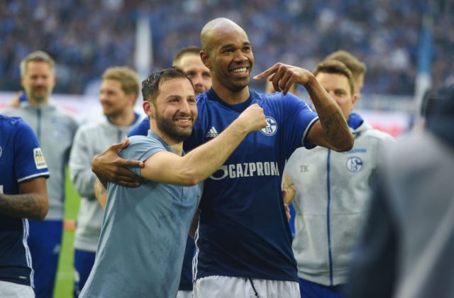 Schalke's German headcoach Domenico Tedesco and Schalke's Brazilian defender Naldo celebrate celebrate after the German first division Bundesliga football match FC Schalke 04 vs Borussia Dortmund, in Gelsenkirchen, western Germany, on April 15, 2018. / AFP PHOTO / Patrik STOLLARZ / RESTRICTIONS: DURING MATCH TIME: DFL RULES TO LIMIT THE ONLINE USAGE TO 15 PICTURES PER MATCH AND FORBID IMAGE SEQUENCES TO SIMULATE VIDEO. == RESTRICTED TO EDITORIAL USE == FOR FURTHER QUERIES PLEASE CONTACT DFL DIRECTLY AT + 49 69 650050 (Photo credit should read PATRIK STOLLARZ/AFP/Getty Images)
