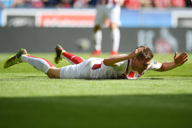 COLOGNE, GERMANY - APRIL 07: Simon Terodde of Koeln lies on the pitch and looks dejected during the Bundesliga match between 1. FC Koeln and 1. FSV Mainz 05 at RheinEnergieStadion on April 7, 2018 in Cologne, Germany. (Photo by Matthias Hangst/Bongarts/Getty Images)