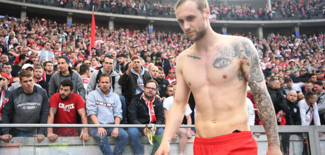 BERLIN, GERMANY - APRIL 14: Supporters of Koelen show their feelings about their team while Marcel Risse of Koeln walks away, after the Bundesliga match between Hertha BSC and 1. FC Koeln at Olympiastadion on April 14, 2018 in Berlin, Germany. (Photo by Stuart Franklin/Bongarts/Getty Images)