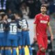 SINSHEIM, GERMANY - MARCH 31: The team of Hoffenheim celebrates the seceding goal and Jonas Hector of Koeln looks dejected during the Bundesliga match between TSG 1899 Hoffenheim and 1. FC Koeln at Wirsol Rhein-Neckar-Arena on March 31, 2018 in Sinsheim, Germany.