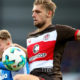 KIEL, GERMANY - SEPTEMBER 19: Marvin Duksch (L) of Kiel and Lasse Sobiech of St. Pauli battle for the ball during the Second Bundesliga match between Holstein Kiel and FC St. Pauli at Holstein-Stadion on September 19, 2017 in Kiel, Germany. (Photo by Martin Rose/Bongarts/Getty Images)