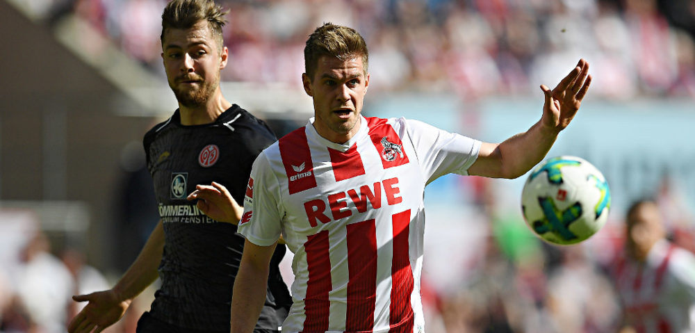 COLOGNE, GERMANY - APRIL 07: Simon Terodde of Stuttgart (r) runs for the ball with Alexander Hack of Mainz during the Bundesliga match between 1. FC Koeln and 1. FSV Mainz 05 at RheinEnergieStadion on April 7, 2018 in Cologne, Germany. (Photo by Matthias Hangst/Bongarts/Getty Images)
