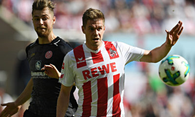 COLOGNE, GERMANY - APRIL 07: Simon Terodde of Stuttgart (r) runs for the ball with Alexander Hack of Mainz during the Bundesliga match between 1. FC Koeln and 1. FSV Mainz 05 at RheinEnergieStadion on April 7, 2018 in Cologne, Germany. (Photo by Matthias Hangst/Bongarts/Getty Images)