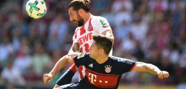 Bayern Munich's Polish forward Robert Lewandowski (bottom) and Cologne's Slovenian defender Dominic Maroh (top, L) vie for the ball during the German first division Bundesliga football match FC Cologne vs FC Bayern Munich in Cologne, western Germany, on May 5, 2018. (Photo by Patrik STOLLARZ / AFP) / RESTRICTIONS: DURING MATCH TIME: DFL RULES TO LIMIT THE ONLINE USAGE TO 15 PICTURES PER MATCH AND FORBID IMAGE SEQUENCES TO SIMULATE VIDEO. == RESTRICTED TO EDITORIAL USE == FOR FURTHER QUERIES PLEASE CONTACT DFL DIRECTLY AT + 49 69 650050 (Photo credit should read PATRIK STOLLARZ/AFP/Getty Images)