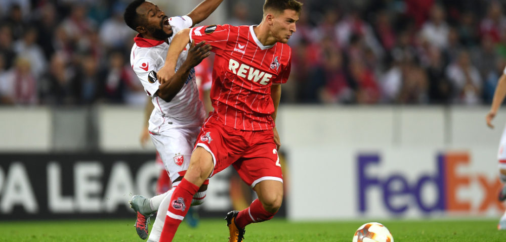 Cologne's midfielder Salih Oezcan and Belgrade´s Guelor Kanga during the UEFA Europa League group H football match between FC Cologne and FC Red Star Belgrade in Cologne, western Germany, on September 28, 2017. / AFP PHOTO / PATRIK STOLLARZ