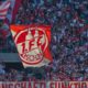 Cologne supporter wave flags during the German first division Bundesliga football match FC Cologne vs FC Bayern Munich in Cologne, western Germany, on May 5, 2018. (Photo by Patrik STOLLARZ / AFP) / RESTRICTIONS: DURING MATCH TIME: DFL RULES TO LIMIT THE ONLINE USAGE TO 15 PICTURES PER MATCH AND FORBID IMAGE SEQUENCES TO SIMULATE VIDEO. == RESTRICTED TO EDITORIAL USE == FOR FURTHER QUERIES PLEASE CONTACT DFL DIRECTLY AT + 49 69 650050 (Photo credit should read PATRIK STOLLARZ/AFP/Getty Images)