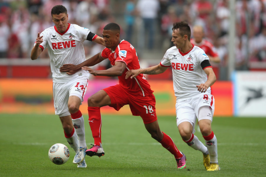 COLOGNE, GERMANY - JULY 28: Jonas Hector of Koeln (L) and Adam Matuschyk of Koeln (R) challenge Mathis Bolly of Duesseldorf (C) during the Second Bundesliga match between 1. FC Koeln and Fortuna Duesseldorf at RheinEnergieStadion on July 28, 2013 in Cologne, Germany. (Photo by Christof Koepsel/Bongarts/Getty Images)