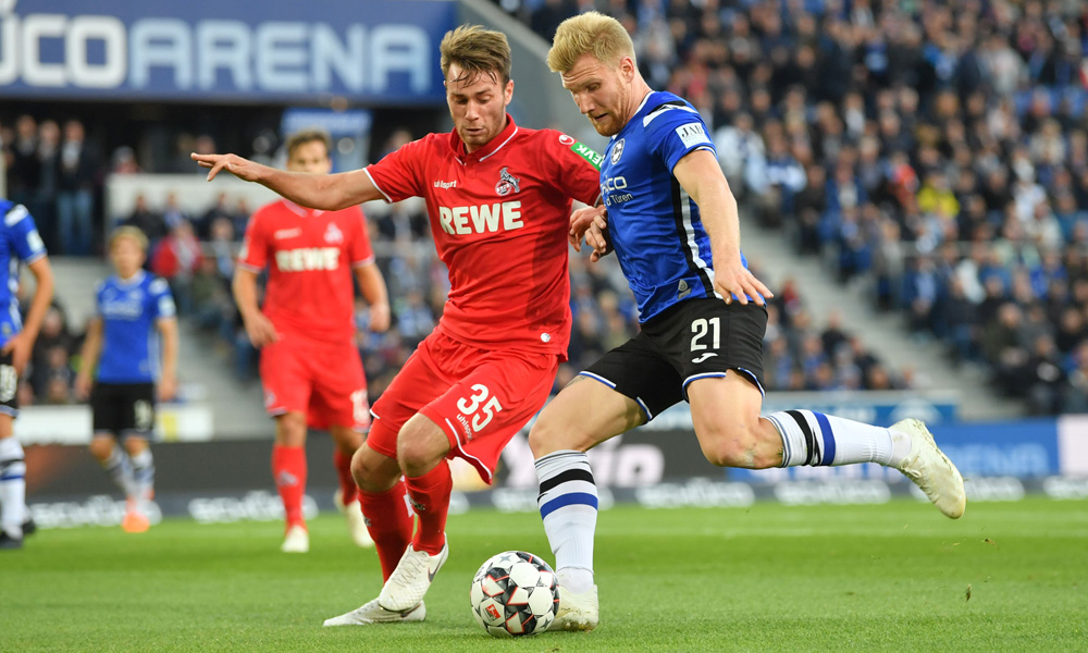 BIELEFELD, GERMANY - SEPTEMBER 28: Matthias Bader (L) of Koeln and Fabian Klos of Bielefeld fight for the ball during the Second Bundesliga match between DSC Arminia Bielefeld and 1. FC Koeln at Schueco Arena on September 28, 2018 in Bielefeld, Germany. (Photo by Thomas Starke/Bongarts/Getty Images)