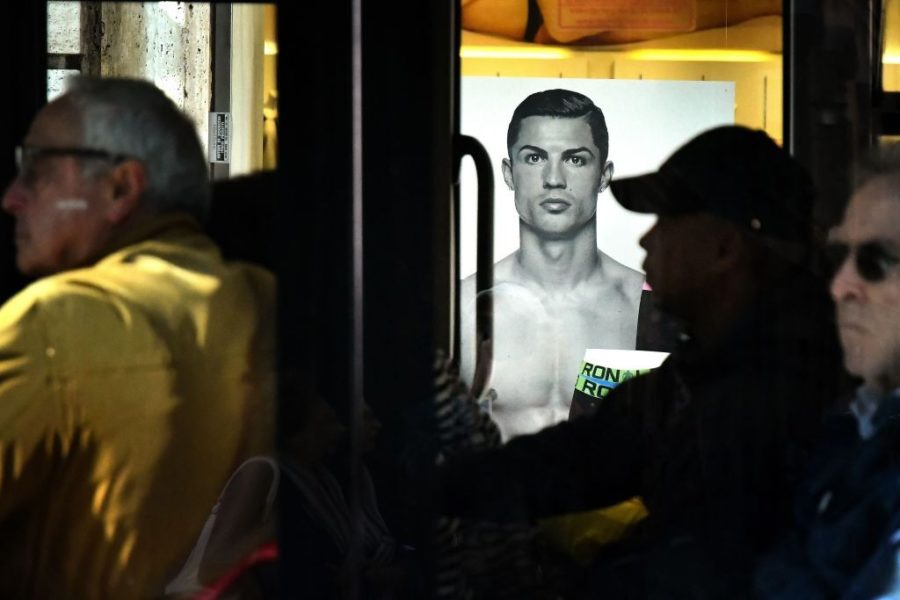 A passenger bus drives past an advertising poster for an underwear brand, showing a picture of Juventus' Portuguese forward Cristiano Ronaldo, on October 9, 2018 in downtown Rome. - Cristiano Ronaldo faces rape allegations after US police on October 1, 2018 re-opened an investigation into claims by former American model Kathryn Mayorga that the five-time Ballon d'Or winner raped her in a Las Vegas hotel in June 2009. (Photo by Alberto PIZZOLI / AFP) (Photo credit should read ALBERTO PIZZOLI/AFP/Getty Images)