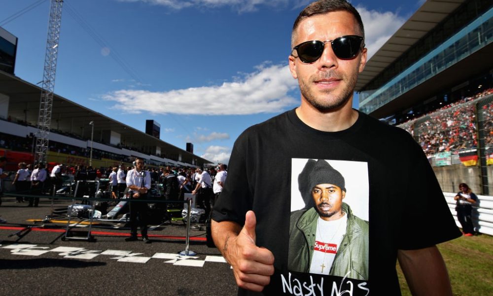 SUZUKA, JAPAN - OCTOBER 07: German football player Lukas Podolski poses for a photo on the grid before the Formula One Grand Prix of Japan at Suzuka Circuit on October 7, 2018 in Suzuka. (Photo by Mark Thompson/Getty Images)