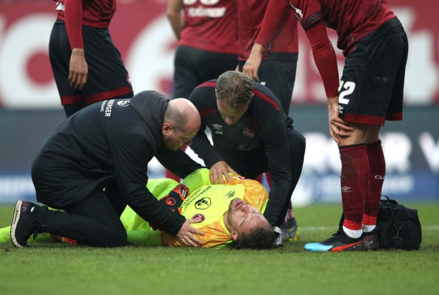 NUREMBERG, GERMANY - FEBRUARY 02: Christian Mathenia of FC Nuernberg receives medical treatment during the Bundesliga match between 1. FC Nuernberg and SV Werder Bremen at Max-Morlock-Stadion on February 2, 2019 in Nuremberg, Germany. (Photo by Adam Pretty/Bongarts/Getty Images)