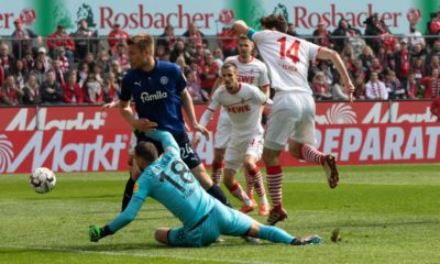 COLOGNE, GERMANY - MARCH 31: Jonas Hector of Cologne (R) and goalkeeper Kenneth Kronholm of Kiel battle for the ball during the Second Bundesliga match between 1. FC Koeln and Holstein Kiel at RheinEnergieStadion on March 31, 2019 in Cologne, Germany. (Photo by Juergen Schwarz/Bongarts/Getty Images)