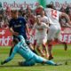 COLOGNE, GERMANY - MARCH 31: Jonas Hector of Cologne (R) and goalkeeper Kenneth Kronholm of Kiel battle for the ball during the Second Bundesliga match between 1. FC Koeln and Holstein Kiel at RheinEnergieStadion on March 31, 2019 in Cologne, Germany. (Photo by Juergen Schwarz/Bongarts/Getty Images)