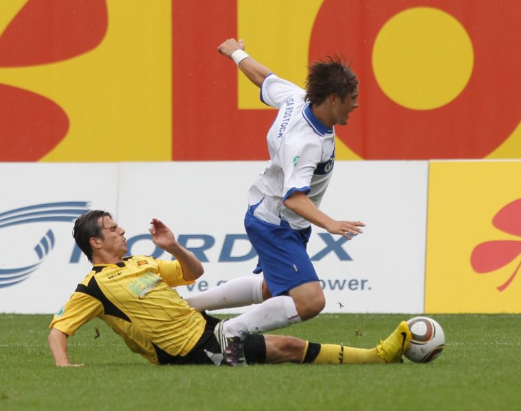 ROSTOCK, GERMANY - AUGUST 08: Kevin Pannewitz (R) of Rostock and Massimo Cannizzaro (L) of Koblenz battle for the ball during the Third League match between Hansa Rostock and TuS Koblenz at the DKB Arena on August 8, 2010 in Rostock, Germany. (Photo by Boris Streubel/Bongarts/Getty Images)