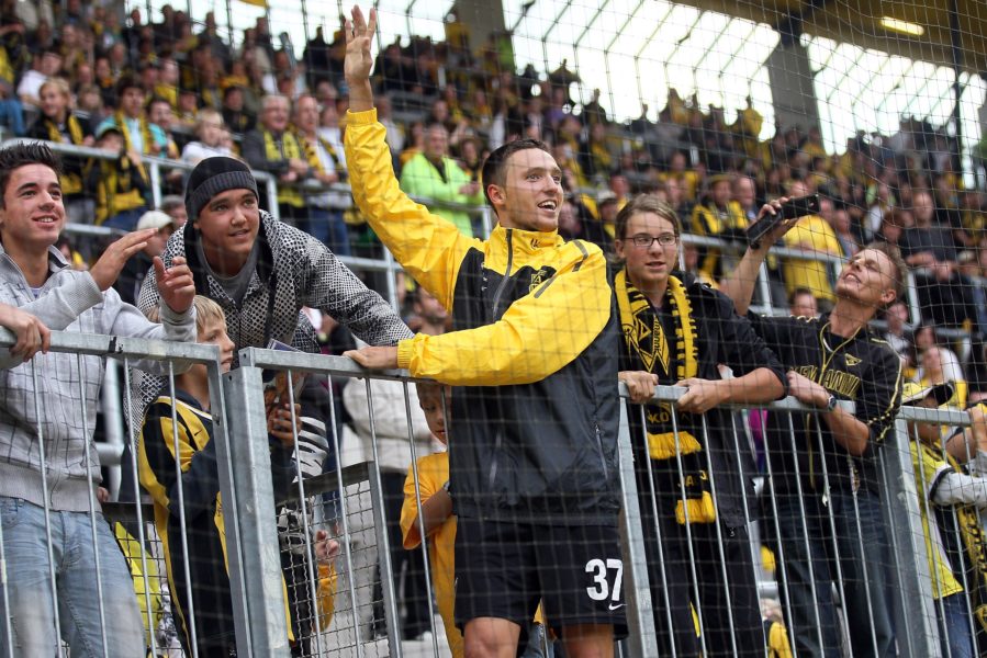 AACHEN, GERMANY - AUGUST 08: Marco Hoeger of Aachen celebrates with the fans after winning 2-0 the Derby Cup 2010 match between Alemannia Aachen and Bayer Leverkusen at the Tivoli Stadium on August 8, 2010 in Aachen, Germany. (Photo by Christof Koepsel/Bongarts/Getty Images)