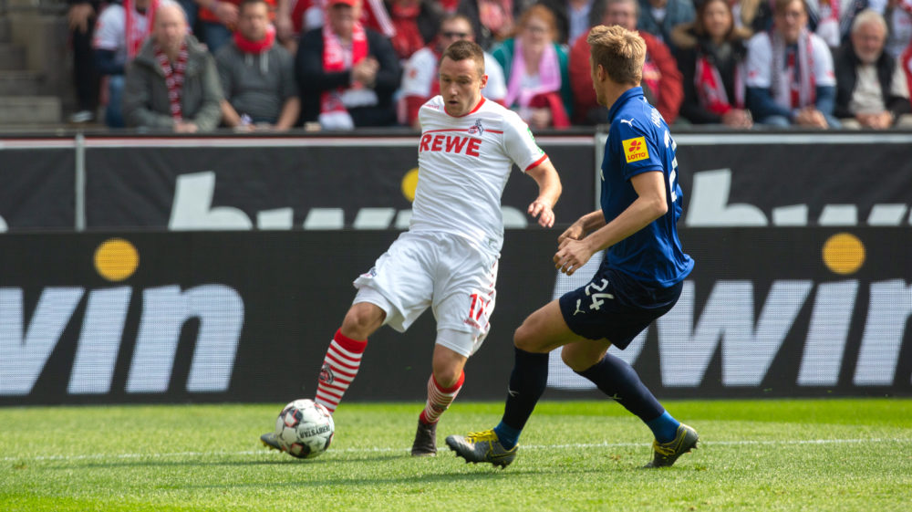 COLOGNE, GERMANY - MARCH 31: Christian Clemens of Cologne (L) and Hauke Wahl of Kiel battle for the ball during the Second Bundesliga match between 1. FC Koeln and Holstein Kiel at RheinEnergieStadion on March 31, 2019 in Cologne, Germany. (Photo by Juergen Schwarz/Bongarts/Getty Images)