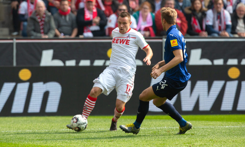 COLOGNE, GERMANY - MARCH 31: Christian Clemens of Cologne (L) and Hauke Wahl of Kiel battle for the ball during the Second Bundesliga match between 1. FC Koeln and Holstein Kiel at RheinEnergieStadion on March 31, 2019 in Cologne, Germany. (Photo by Juergen Schwarz/Bongarts/Getty Images)