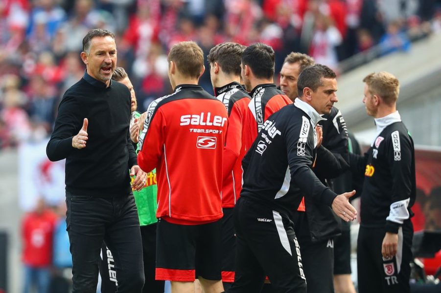 COLOGNE, GERMANY - MAY 12: Head Coach Achim Beierlorzer of SSV Jahn Regensburg celebrates with his players after Sargis Adamyan of SSV Jahn Regensburg (not in picture) scored his team's second goal during the Second Bundesliga match between 1. FC Koeln and SSV Jahn Regensburg at RheinEnergieStadion on May 12, 2019 in Cologne, Germany. (Photo by Lars Baron/Bongarts/Getty Images)