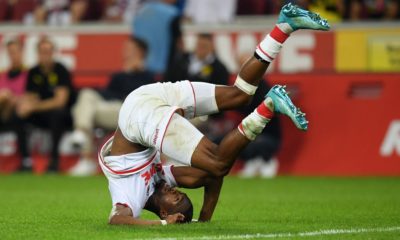 COLOGNE, GERMANY - AUGUST 23: Kingsley Ehizibue of 1. FC Koeln tumbles over during the Bundesliga match between 1. FC Koeln and Borussia Dortmund at RheinEnergieStadion on August 23, 2019 in Cologne, Germany. (Photo by Matthias Hangst/Bongarts/Getty Images)