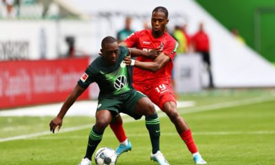 WOLFSBURG, GERMANY - AUGUST 17: Jerome Roussillon of VfL Wolfsburg is challenged by Kingsley Ehizibue of 1. FC Koln during the Bundesliga match between VfL Wolfsburg and 1. FC Koeln at Volkswagen Arena on August 17, 2019 in Wolfsburg, Germany. (Photo by Martin Rose/Bongarts/Getty Images)