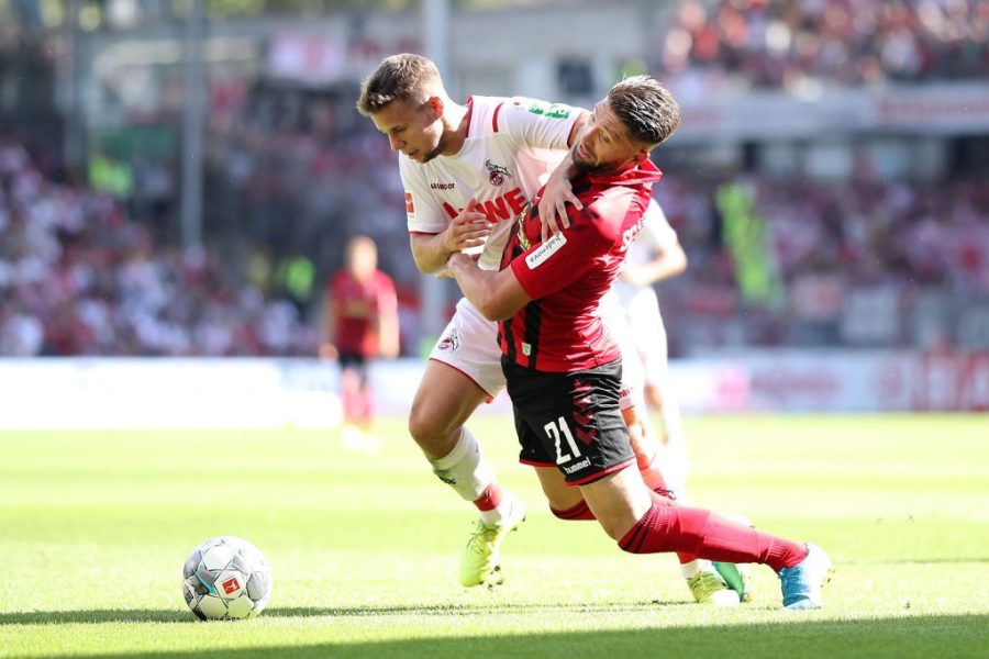 FREIBURG IM BREISGAU, GERMANY - AUGUST 31: Brandon Borrello of Sport-Club Freiburg is challenged by Louis Schaub of 1. FC Koln during the Bundesliga match between Sport-Club Freiburg and 1. FC Koeln at Schwarzwald-Stadion on August 31, 2019 in Freiburg im Breisgau, Germany. (Photo by Simon Hofmann/Bongarts/Getty Images)