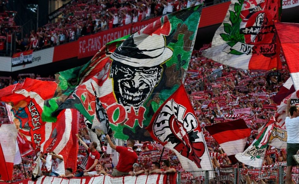 Supporters of FC Cologne wave flags and cheer prior to during the German first division Bundesliga football match 1 FC Cologne v BVB Borussia Dortmund in Cologne, western Germany on August 23, 2019. (Photo by UWE KRAFT / AFP) / RESTRICTIONS: DFL REGULATIONS PROHIBIT ANY USE OF PHOTOGRAPHS AS IMAGE SEQUENCES AND/OR QUASI-VIDEO (Photo credit should read UWE KRAFT/AFP via Getty Images)